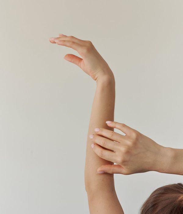 Woman in a graceful yoga pose with magenta light accents.
